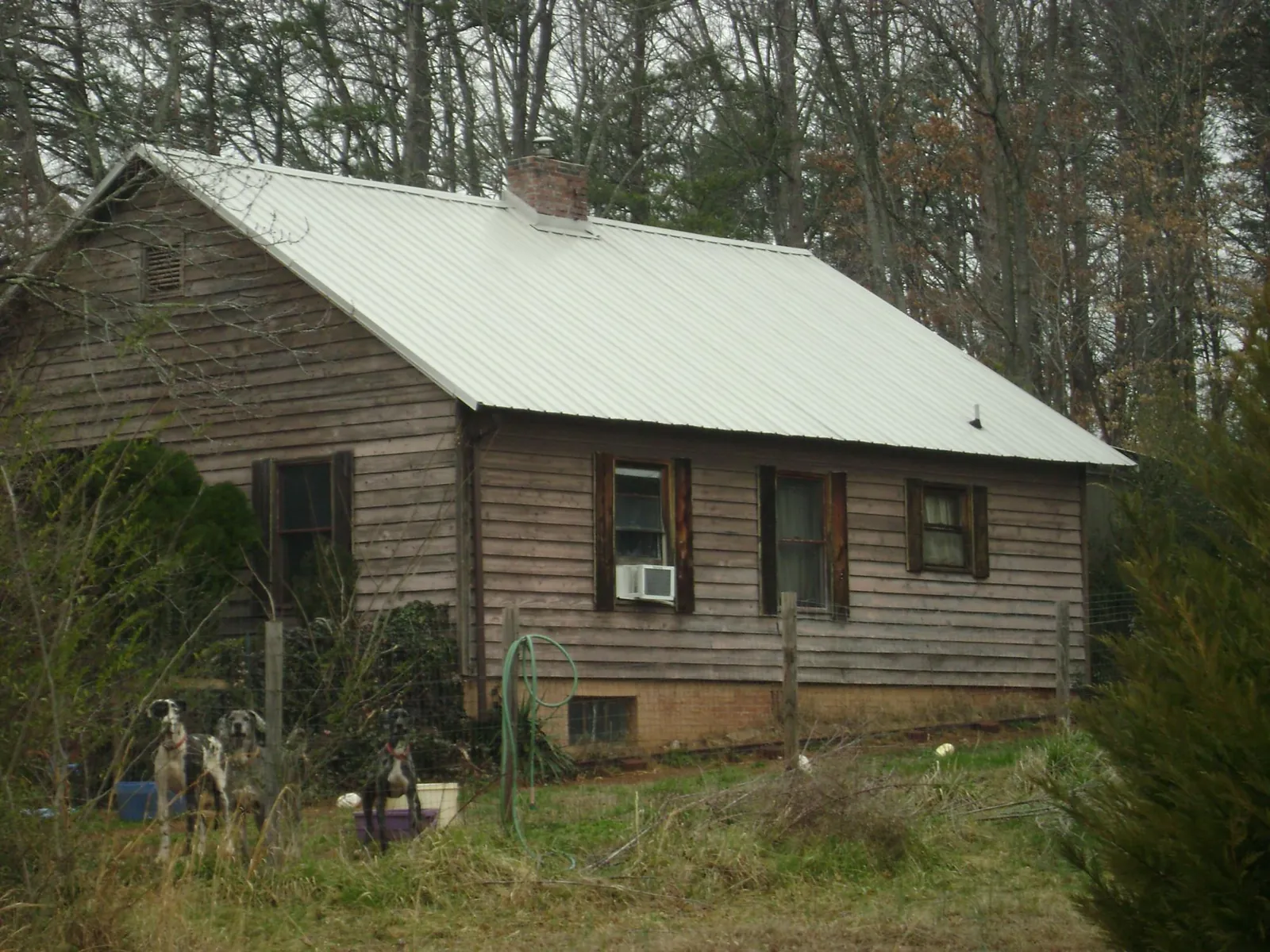 White metal roof on an old wood sided farmhouse, from a Metal Roof Installation job in Marston